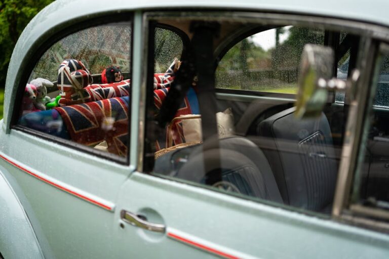 Interior of a vintage car featuring colorful British flag-themed plush toys and accessories.
