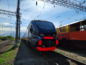A modern Russian train captured under clear skies on railway tracks, highlighting advanced technology.