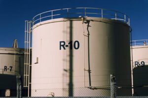 Large industrial storage tanks under blue skies, highlighting metal structures.