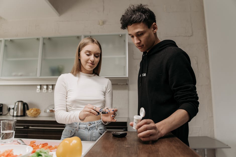 A young couple in a kitchen setting measuring blood sugar levels with a glucometer