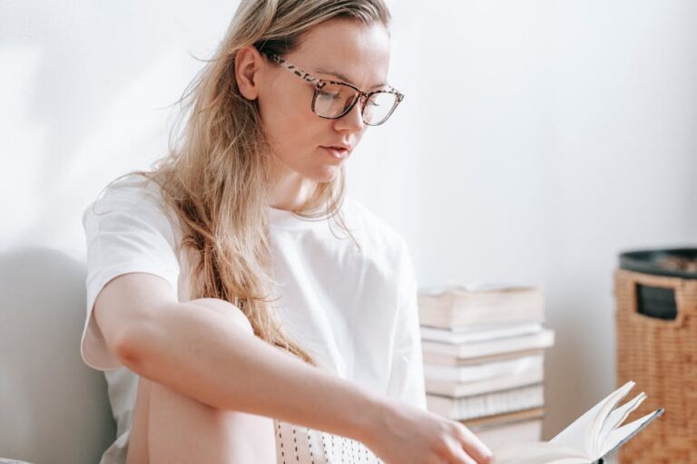 Woman reading a book indoors, capturing a serene and focused mood.