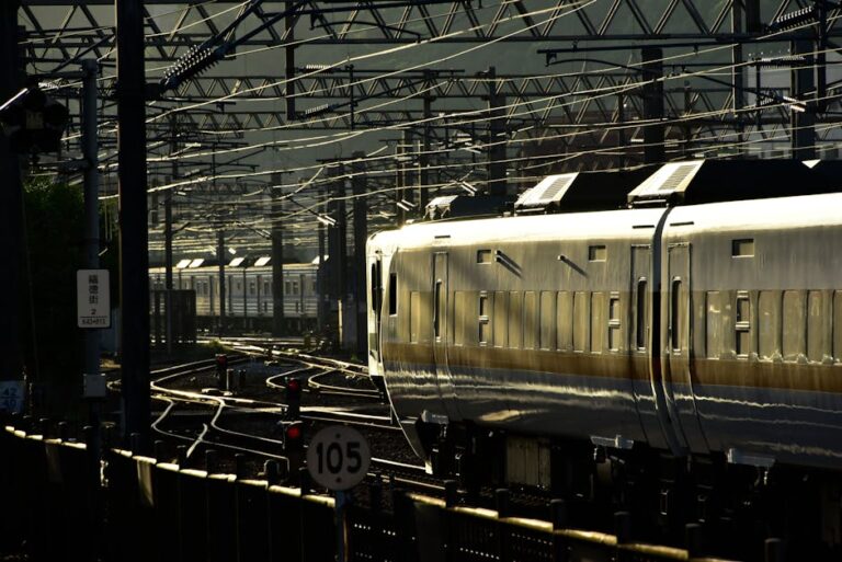 Dynamic image of a high-speed train navigating through complex urban rail tracks at dusk.