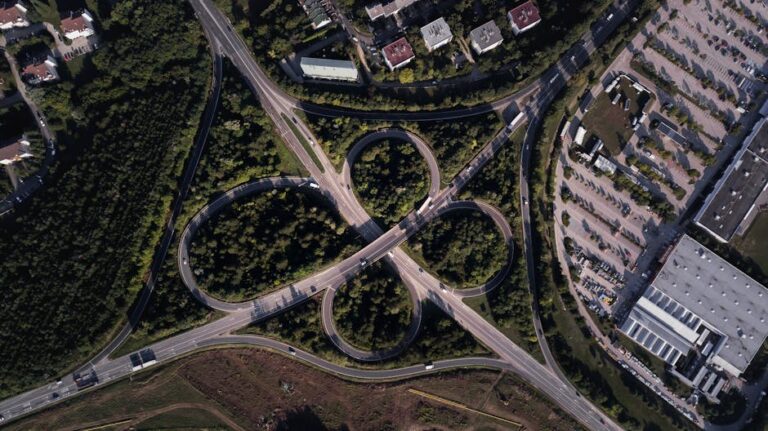 Aerial shot of a complex highway intersection in Veszprém, Hungary, showcasing urban landscape.