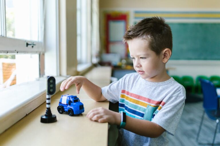 Young boy enjoys playing with toy car indoors, nurturing creativity and fun.