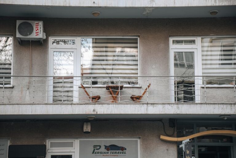 A serene urban balcony featuring two chairs and decor, perfect for relaxation in the city.