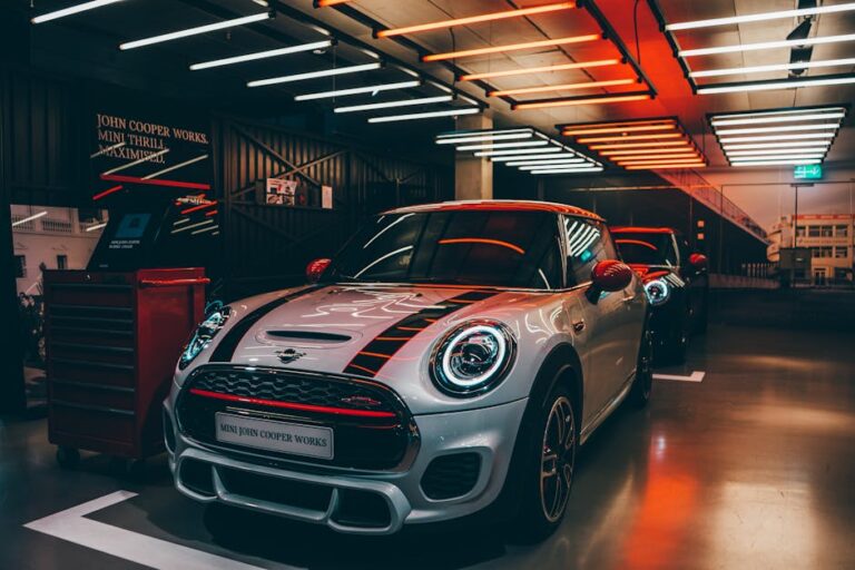 Vibrant Mini Cooper display in a stylish showroom with striking lighting.