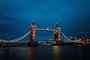A stunning view of the illuminated Tower Bridge in London against a deep blue night sky.