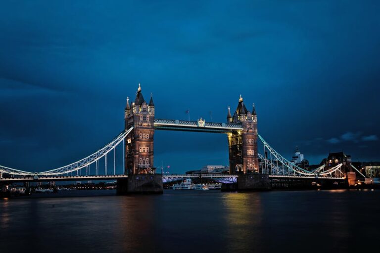 A stunning view of the illuminated Tower Bridge in London against a deep blue night sky.